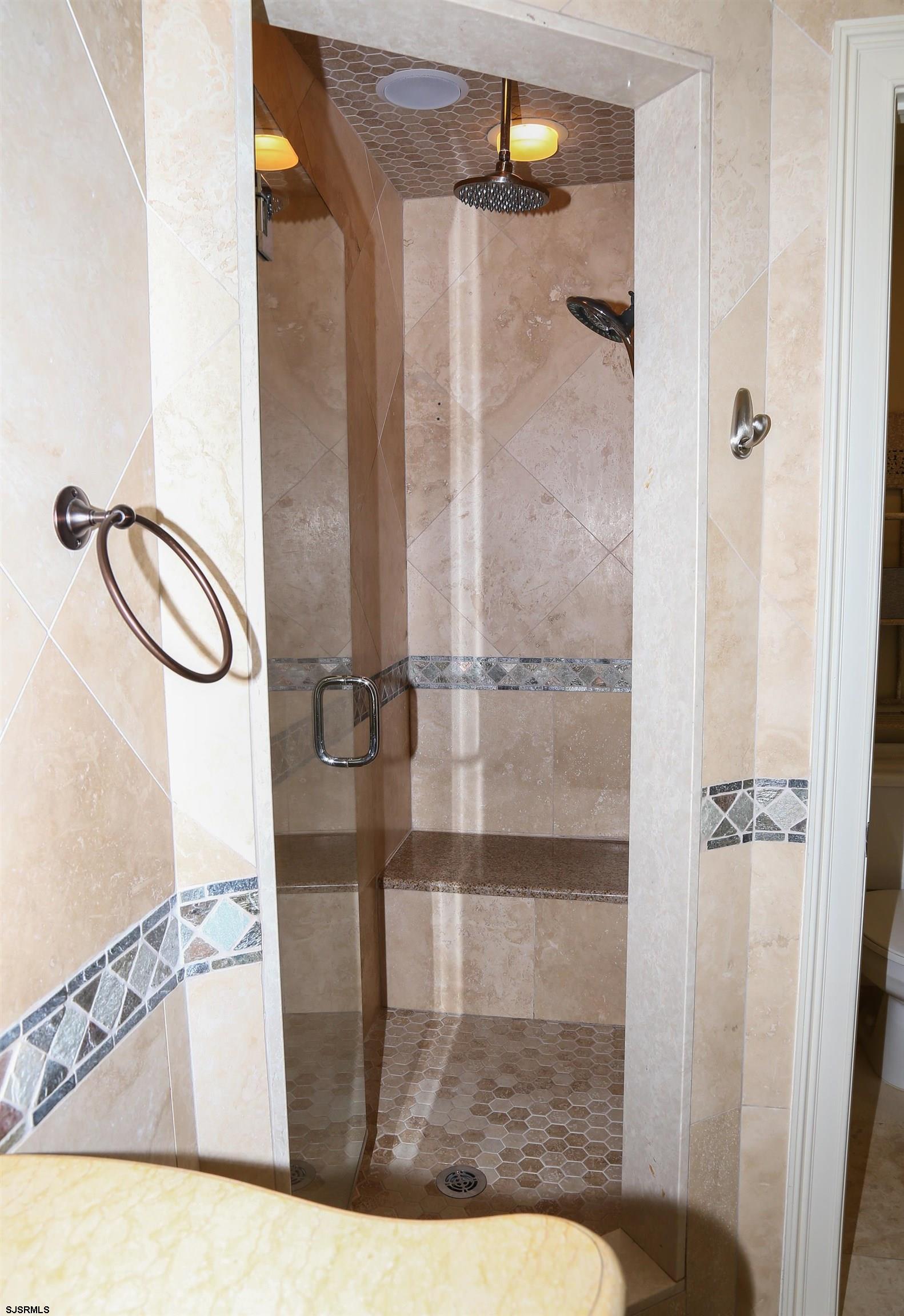 339 South 13th Street Brigantine, NJ 08203 - Photo 42 of 57 a bathroom with a glass shower door
