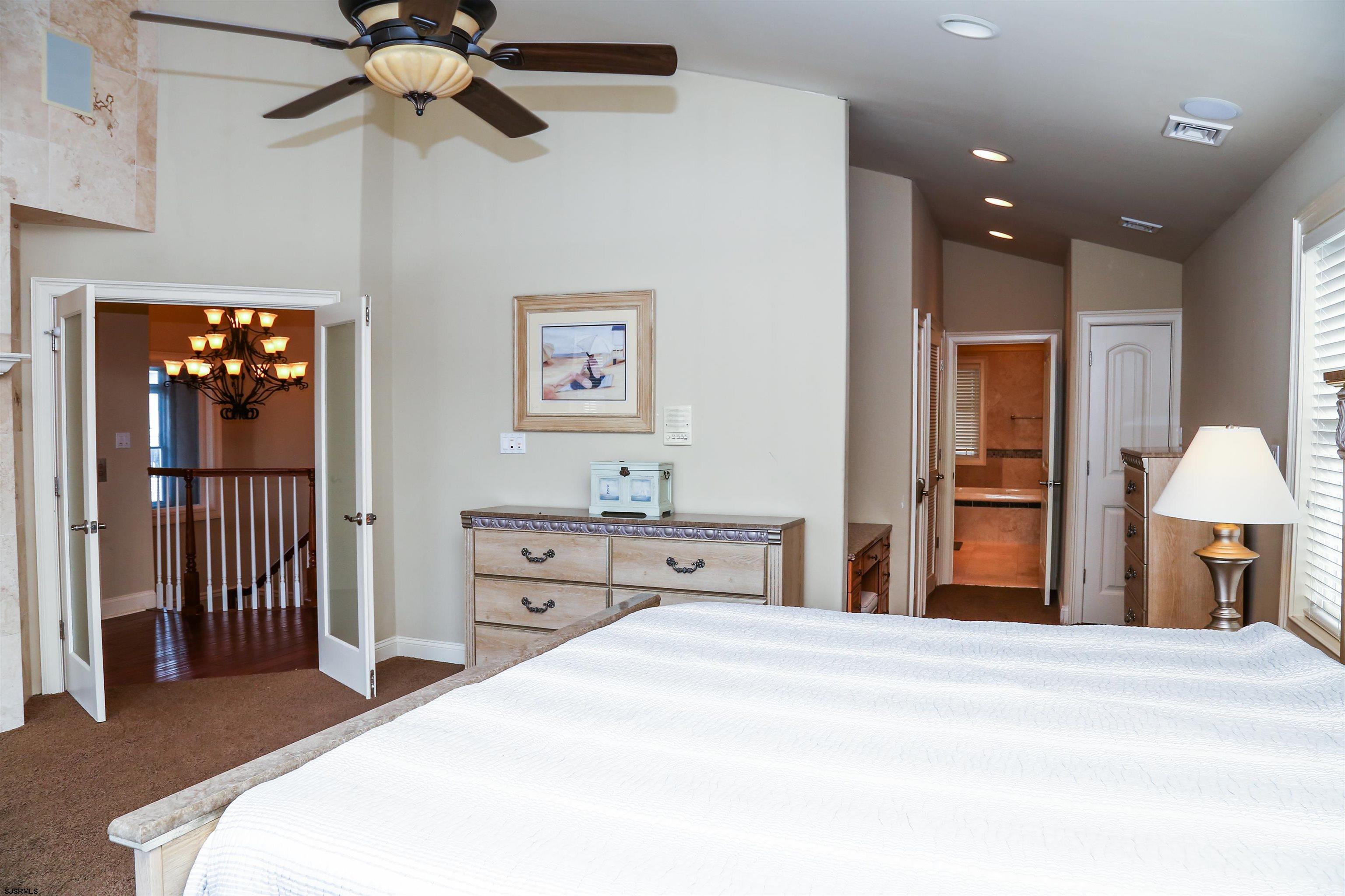 339 South 13th Street Brigantine, NJ 08203 - Photo 44 of 57 a bedroom with a bed and a chandelier