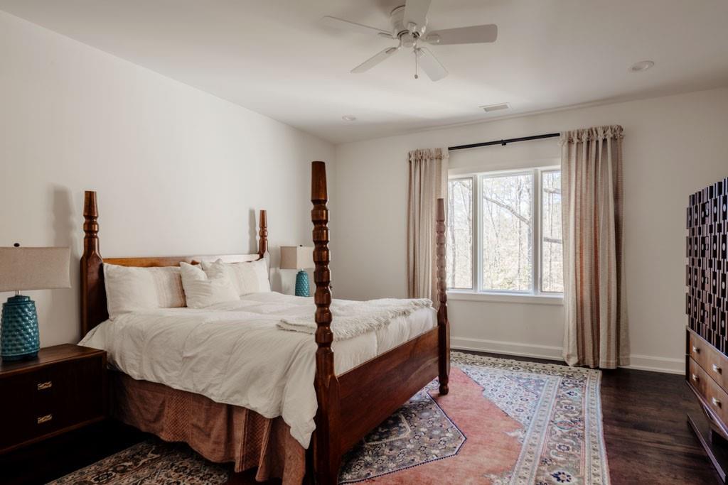 4036 Conway Valley Road Northwest Atlanta, GA 30327 - Photo 20 of 26 a bedroom with a bed and wooden floor