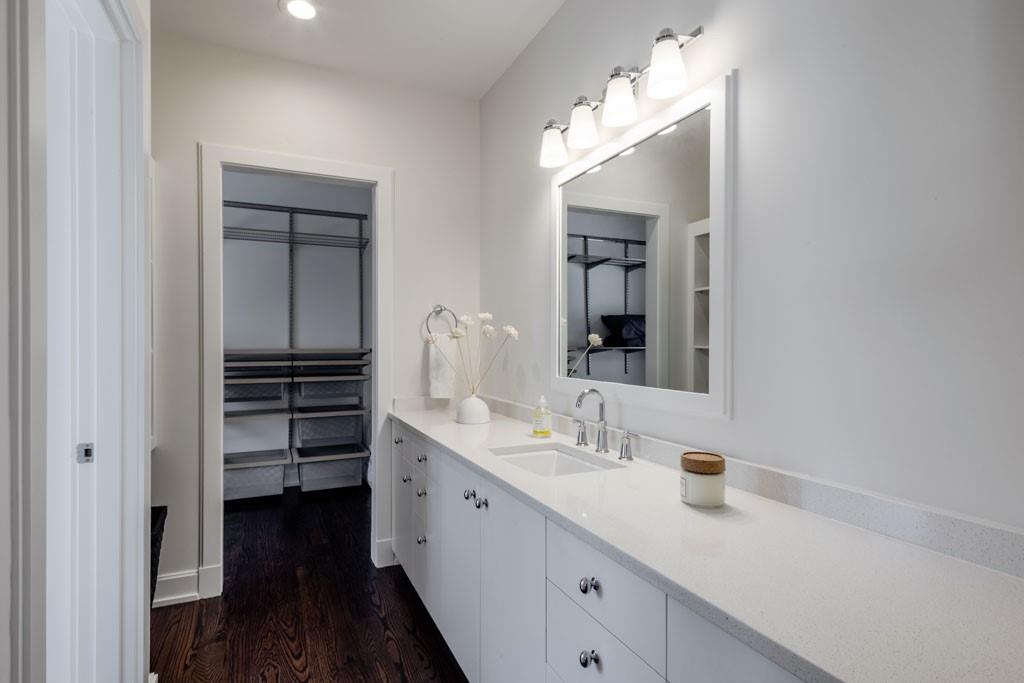 4036 Conway Valley Road Northwest Atlanta, GA 30327 - Photo 22 of 26 a bathroom with a sink a vanity and a mirror