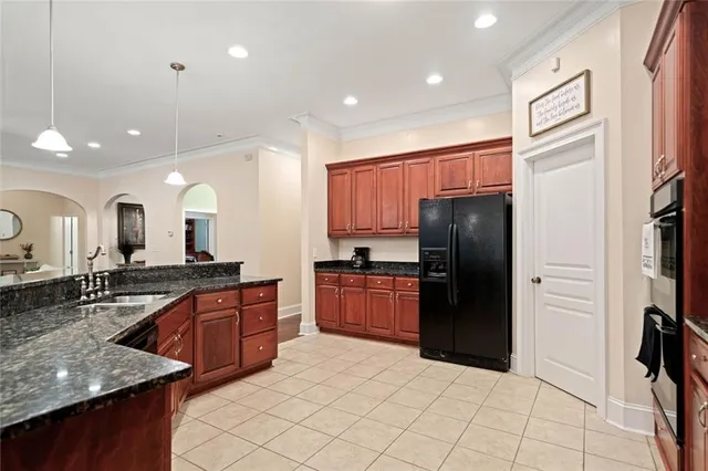 a kitchen with stainless steel appliances granite countertop a refrigerator and a sink