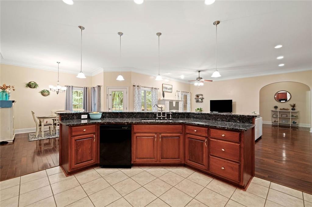 106 Shalea Lane Ball Ground, GA 30107 - Photo 19 of 52 a large kitchen with granite countertop a stove and a sink