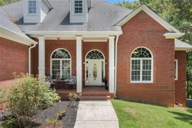 a front view of a house with garden