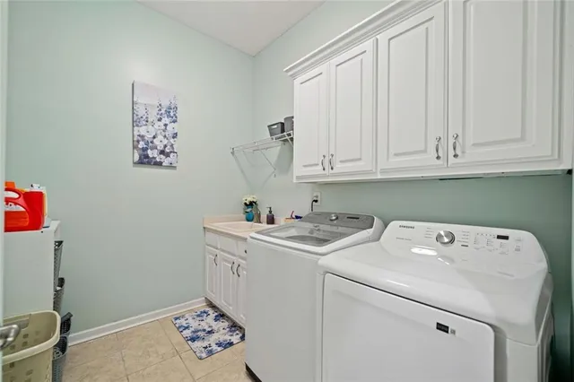 a spacious bedroom with a bed chandelier and a large window