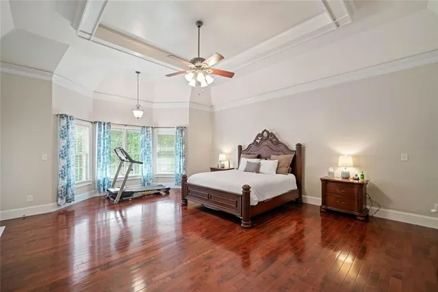 a bedroom with a bed chandelier and a window
