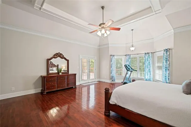 a spacious bedroom with a bed and a chandelier