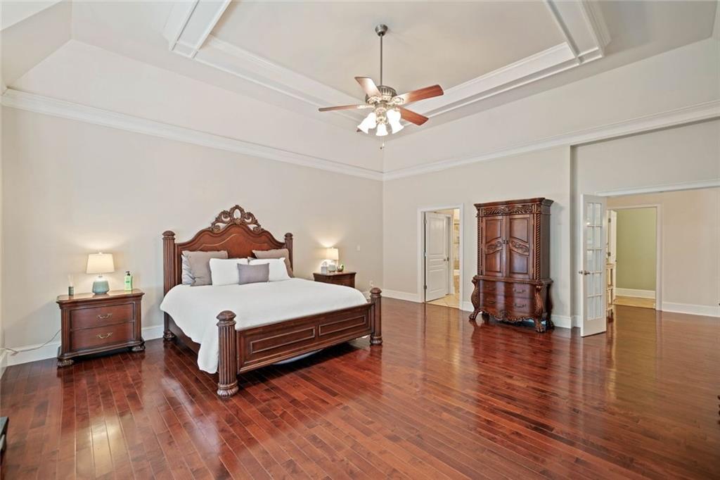 106 Shalea Lane Ball Ground, GA 30107 - Photo 26 of 52 a spacious bedroom with a bed and a chandelier