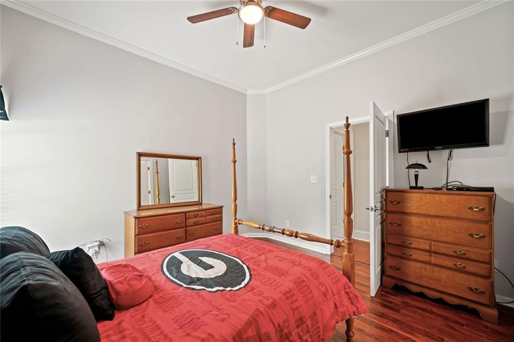 106 Shalea Lane Ball Ground, GA 30107 - Photo 30 of 52 a bedroom with a bed and a flat screen tv