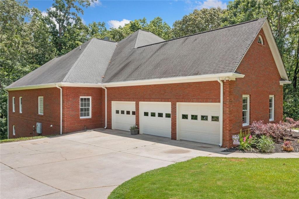 106 Shalea Lane Ball Ground, GA 30107 - Photo 3 of 52 a front view of a house with a yard and garage