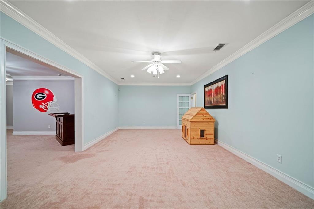 106 Shalea Lane Ball Ground, GA 30107 - Photo 39 of 52 an empty room with windows and ceiling fan