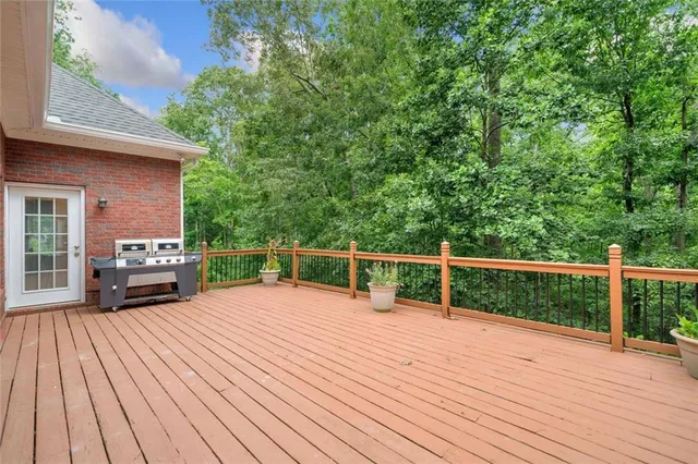 a view of a deck with wooden floor and fence