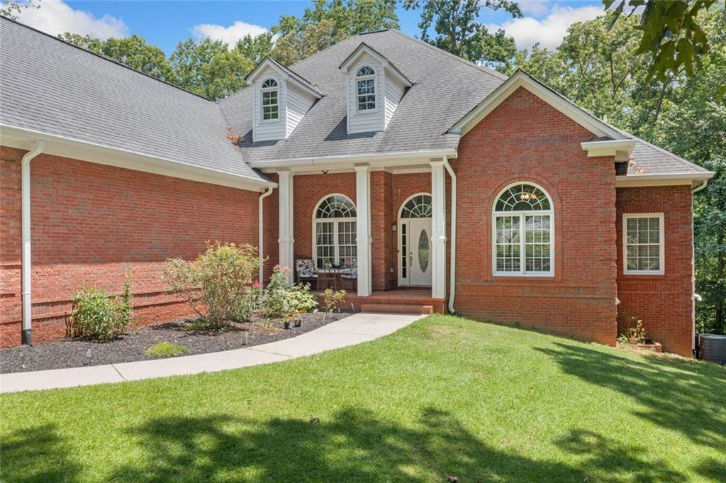 106 Shalea Lane Ball Ground, GA 30107 - Photo 48 of 52 a front view of a house with garden