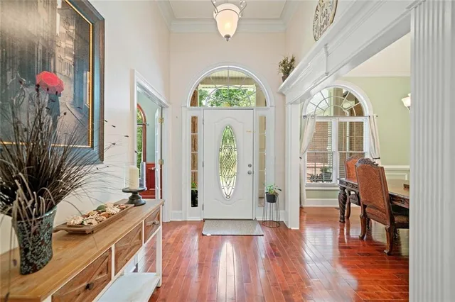 a view of a hallway with wooden floor and windows