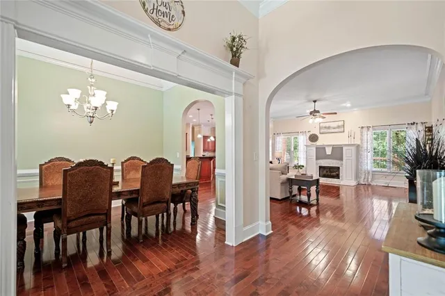 a view of a dining room with furniture wooden floor and chandelier