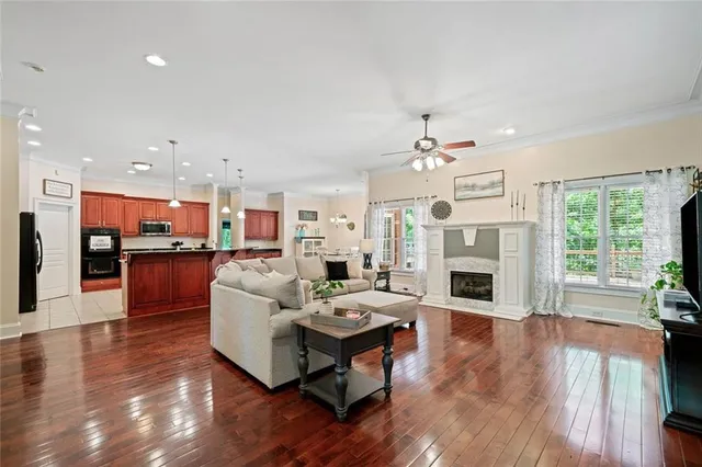 a living room with fireplace furniture and a wooden floor