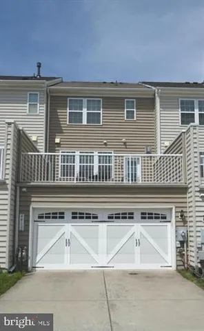a front view of a house with a large window