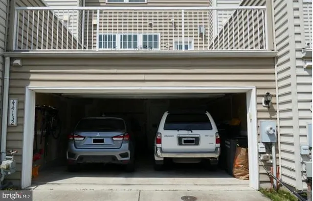 a sign that is sitting in front of a brick house