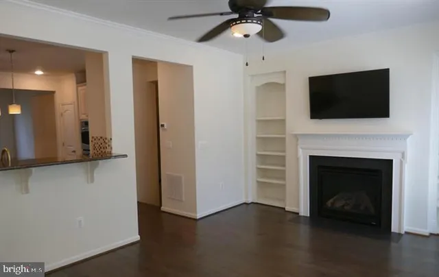 a living room with a fireplace and a flat screen tv
