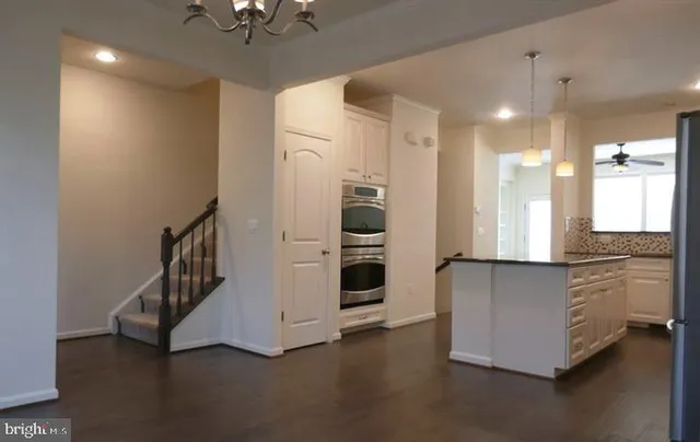 a kitchen with stainless steel appliances a refrigerator and a stove