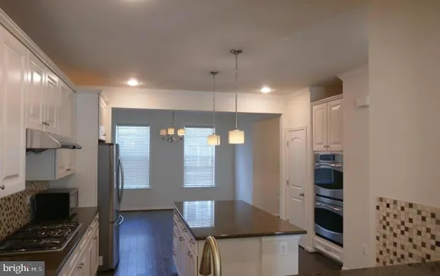 a view of kitchen with furniture and wooden floor