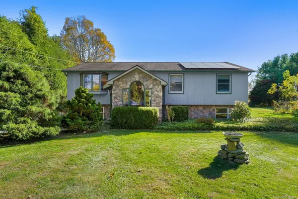 a front view of a house with garden