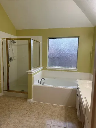 a bathroom with a bathtub and a shower