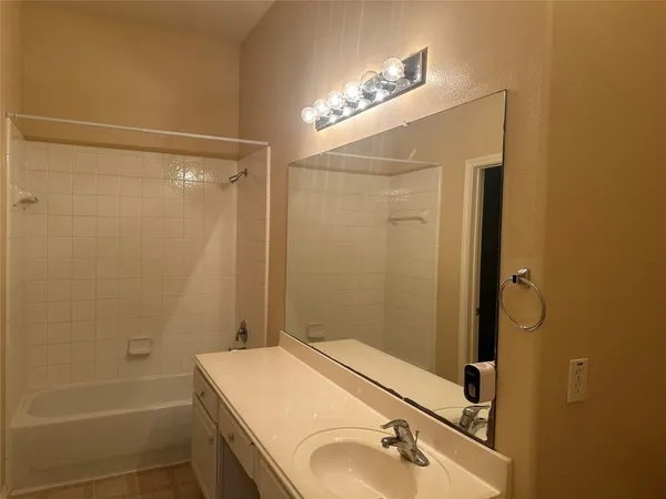 a bathroom with a shower and a sink