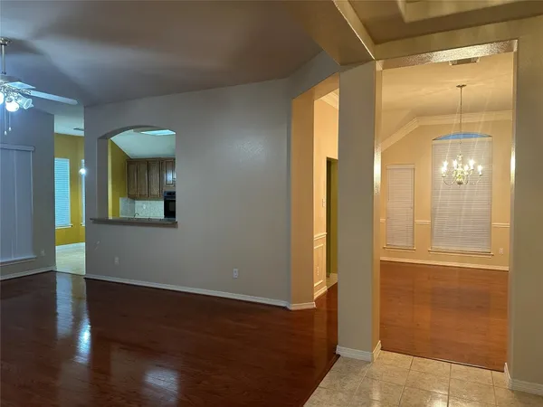 a view of a hallway with wooden floor and glass doors