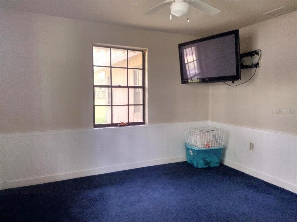 651 Old Haw Creek Road Bunnell, FL 32110 - Photo 5 of 28 a view of an empty room with window and wooden floor