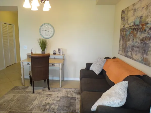 a living room with furniture and a mirror