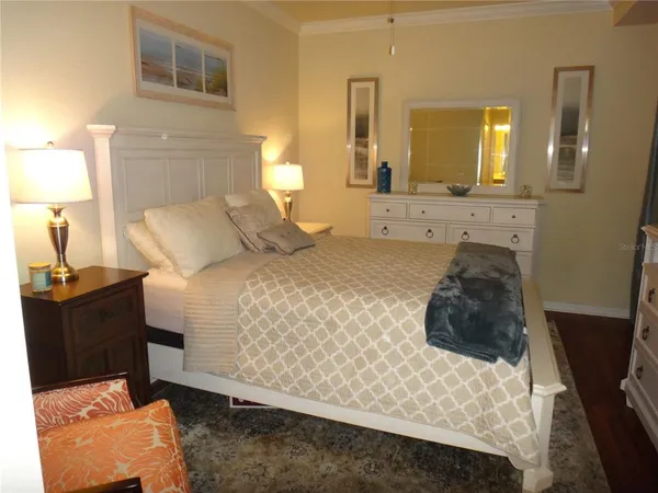 a bedroom with a bed and a mirror
