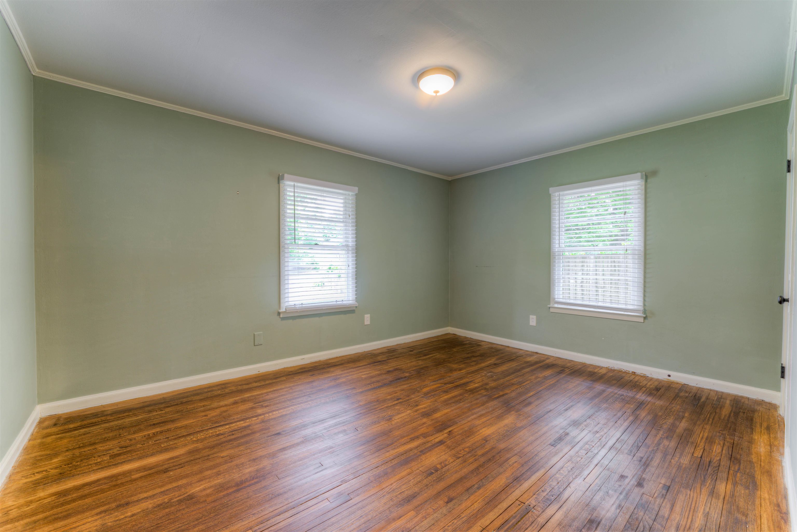 4427 Quince Road Memphis, TN 38117 - Photo 11 of 26 a view of an empty room with wooden floor and a window