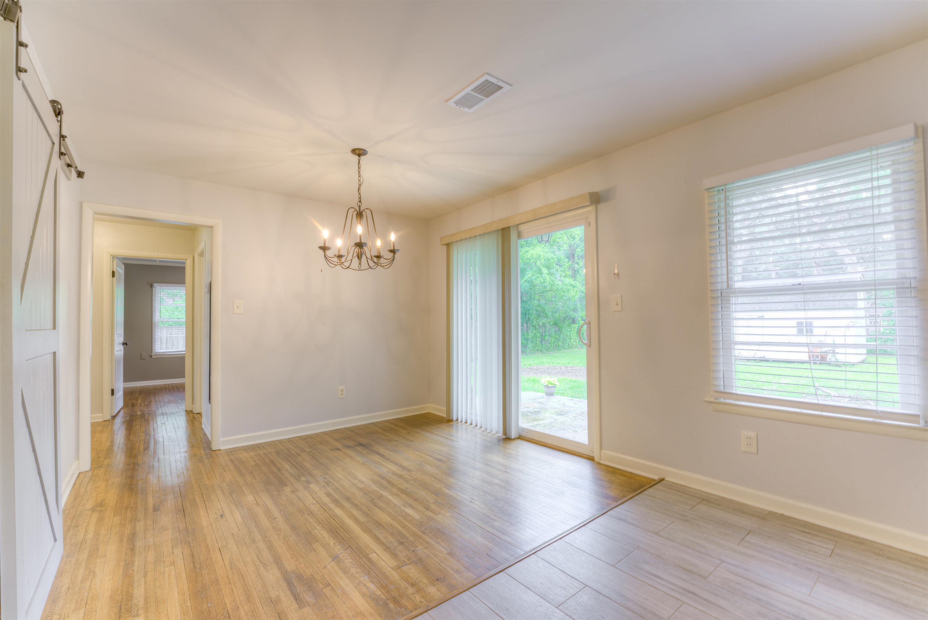 4427 Quince Road Memphis, TN 38117 - Photo 19 of 26 an empty room with wooden floor and windows
