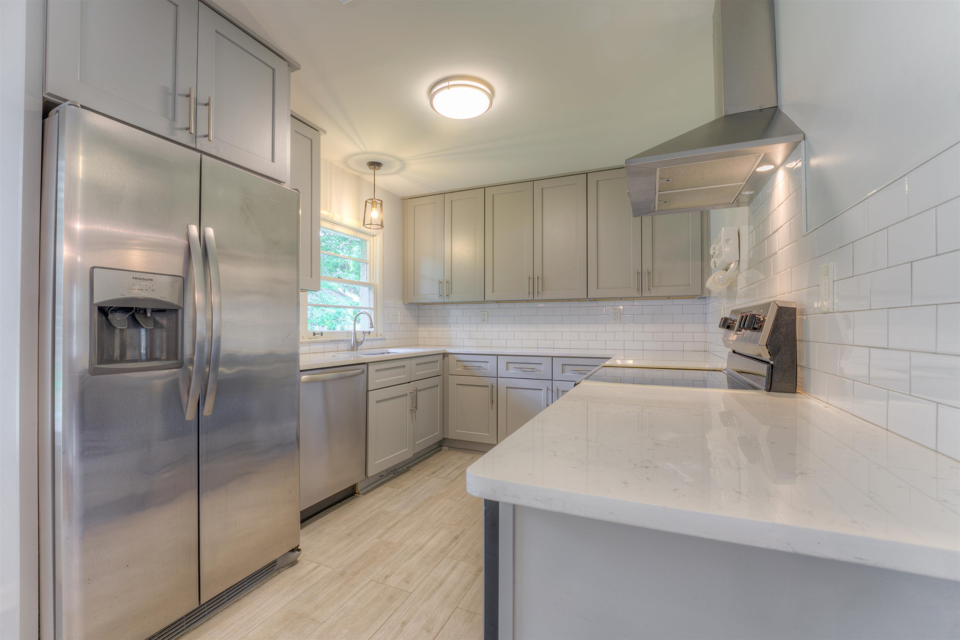 4427 Quince Road Memphis, TN 38117 - Photo 22 of 26 a kitchen with a refrigerator a sink and cabinets