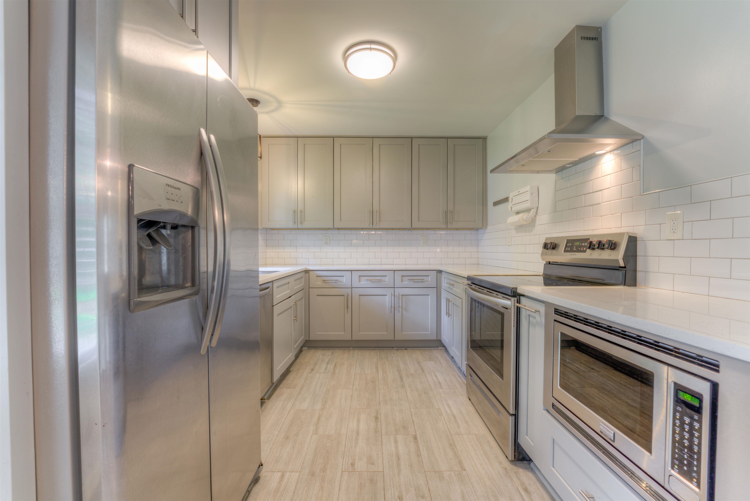 4427 Quince Road Memphis, TN 38117 - Photo 23 of 26 a kitchen with cabinets and stainless steel appliances