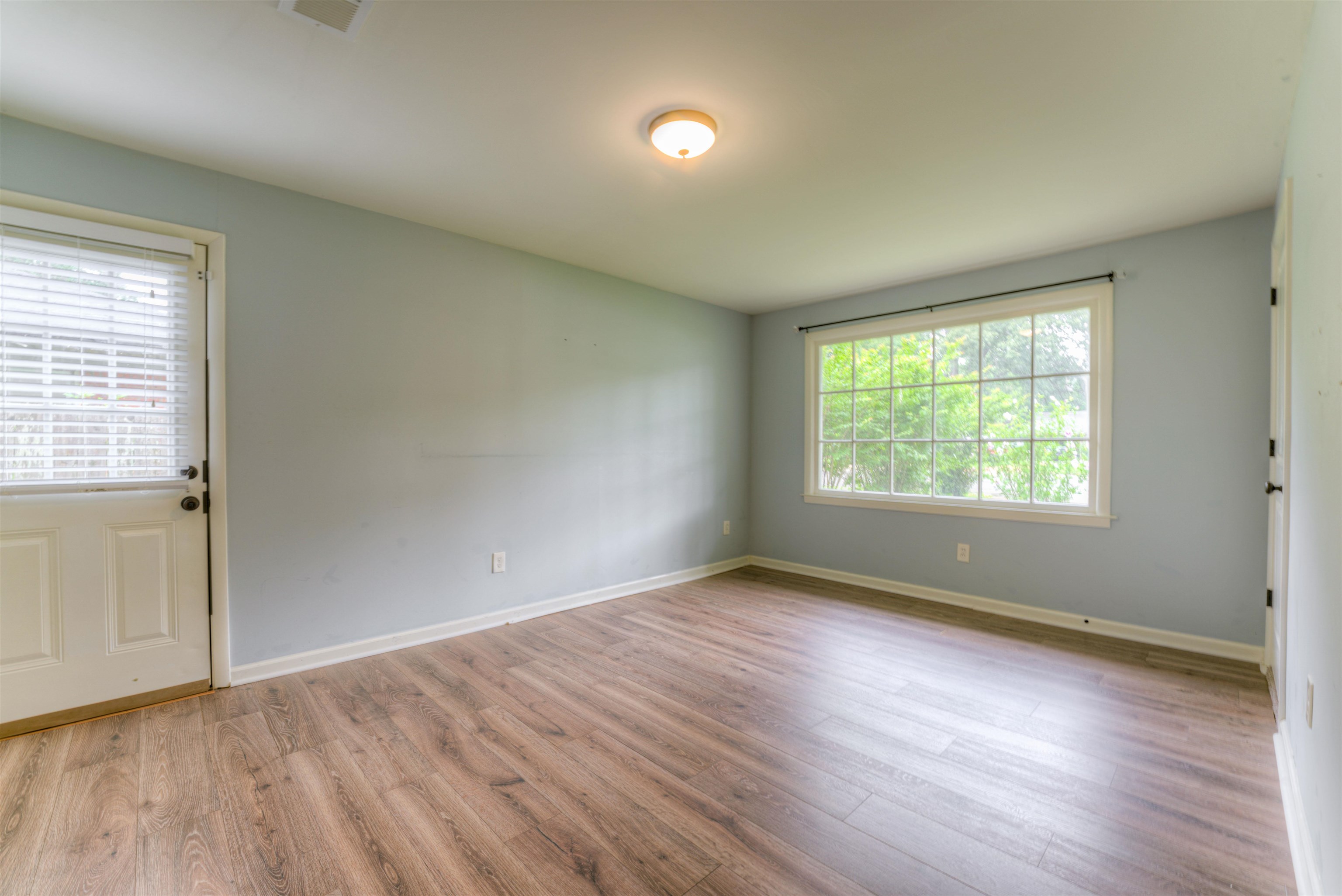 4427 Quince Road Memphis, TN 38117 - Photo 24 of 26 an empty room with wooden floor and windows