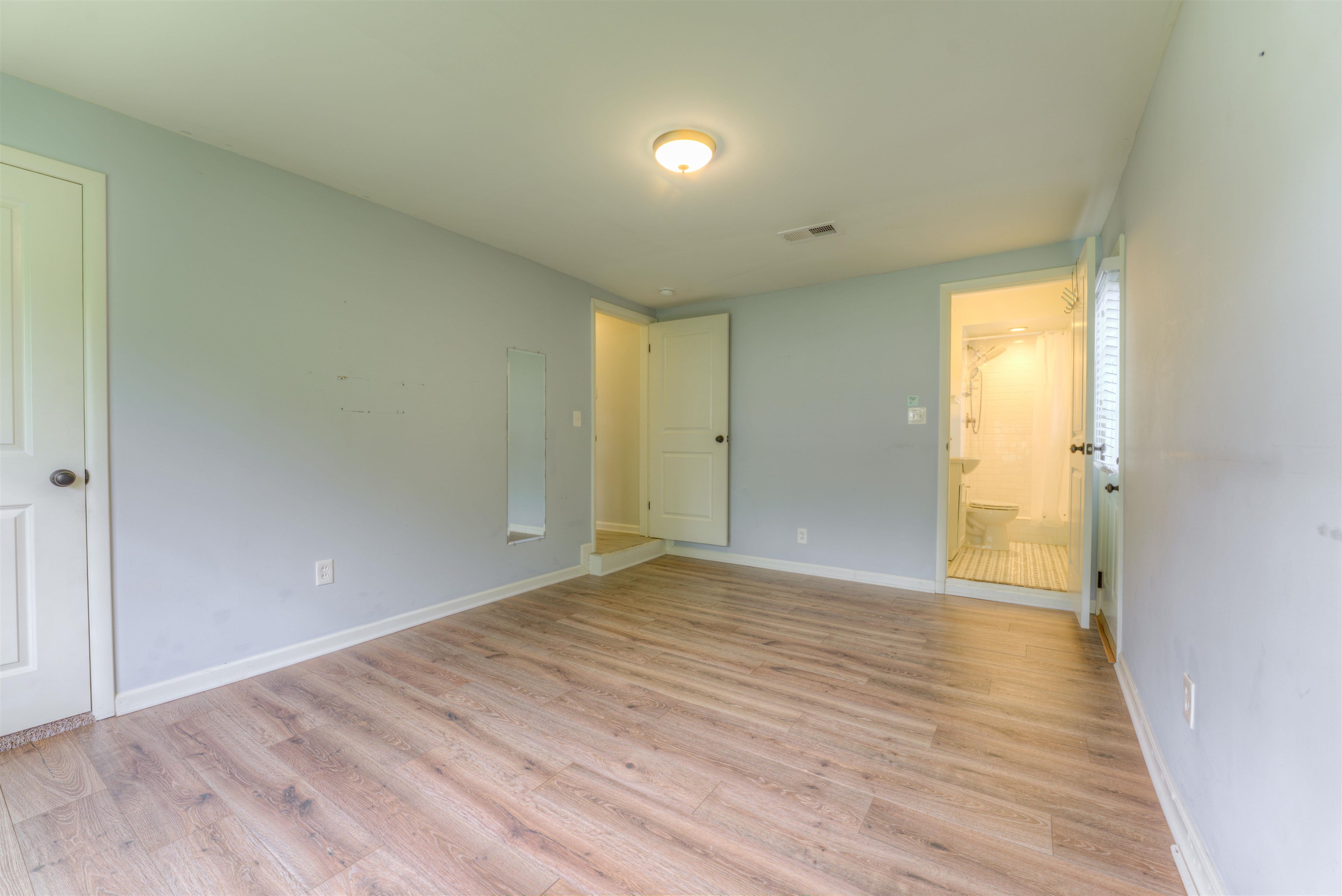 4427 Quince Road Memphis, TN 38117 - Photo 25 of 26 a view of an empty room with wooden floor and a window