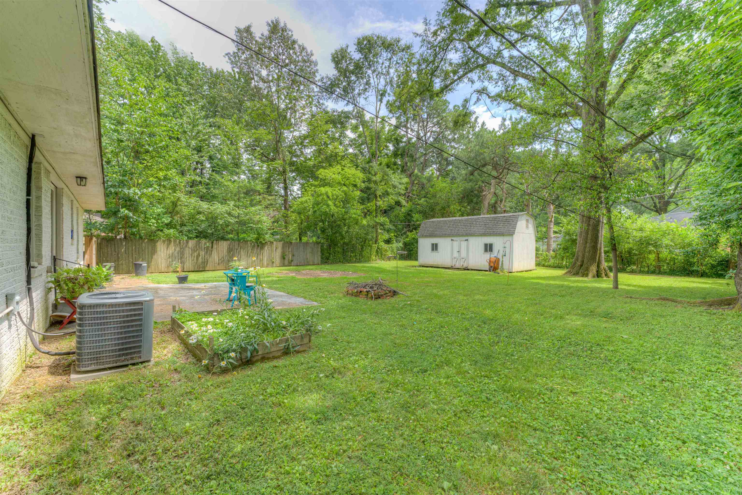 4427 Quince Road Memphis, TN 38117 - Photo 3 of 26 a backyard of a house with table and chairs