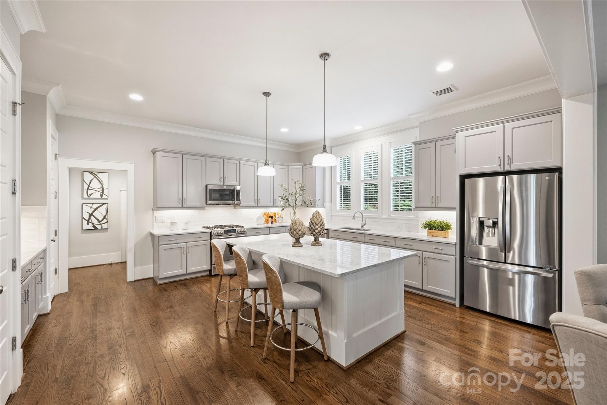 1550 Matthew McClure Circle Davidson, NC 28036 - Photo 13 of 38 a kitchen with stainless steel appliances a dining table chairs stove refrigerator and cabinets