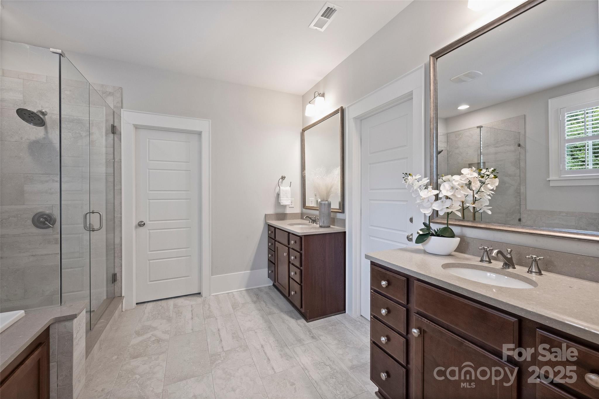 1550 Matthew McClure Circle Davidson, NC 28036 - Photo 24 of 38 a spacious bathroom with a granite countertop sink a mirror and a shower