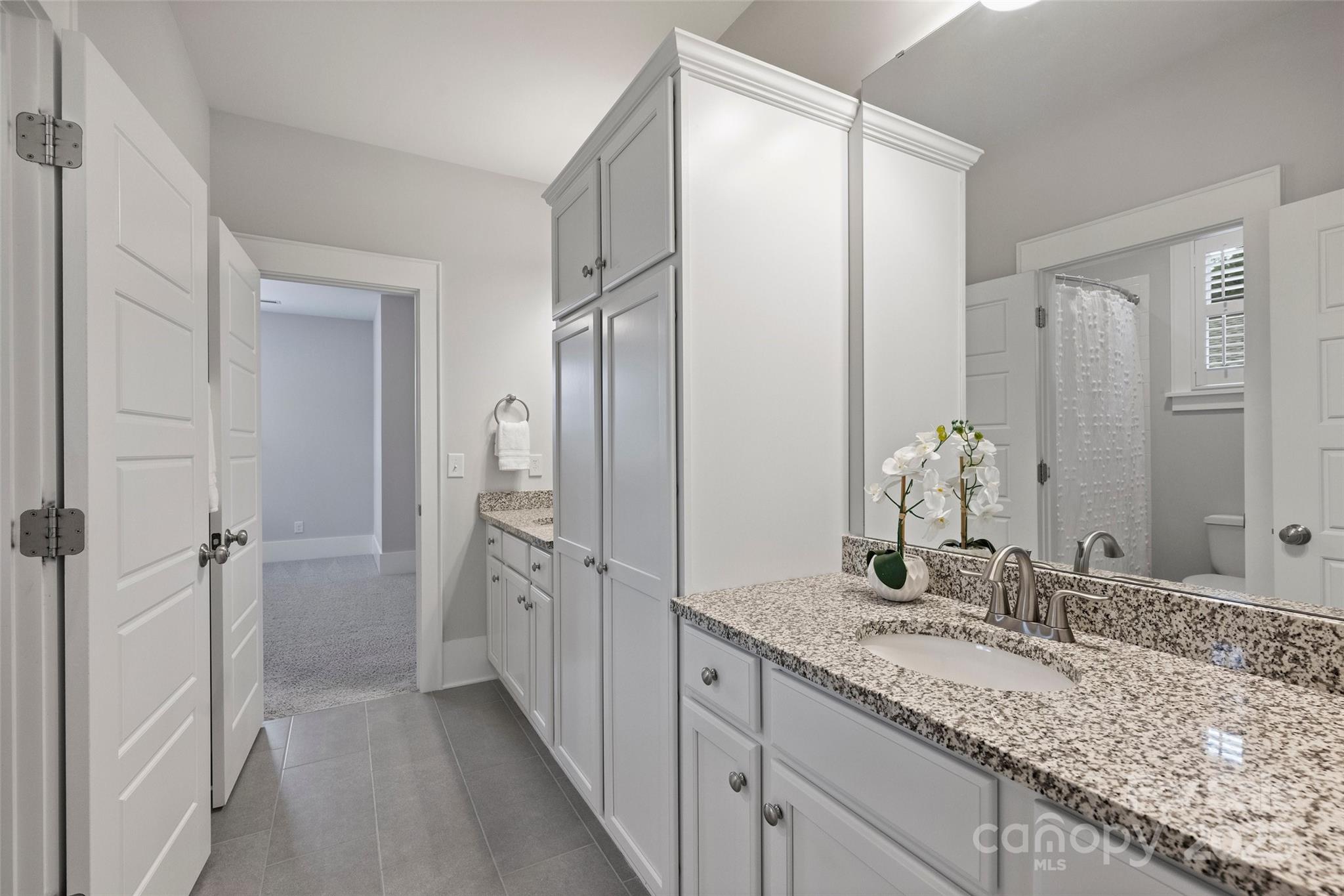 1550 Matthew McClure Circle Davidson, NC 28036 - Photo 29 of 38 a bathroom with a granite countertop sink mirror and shower