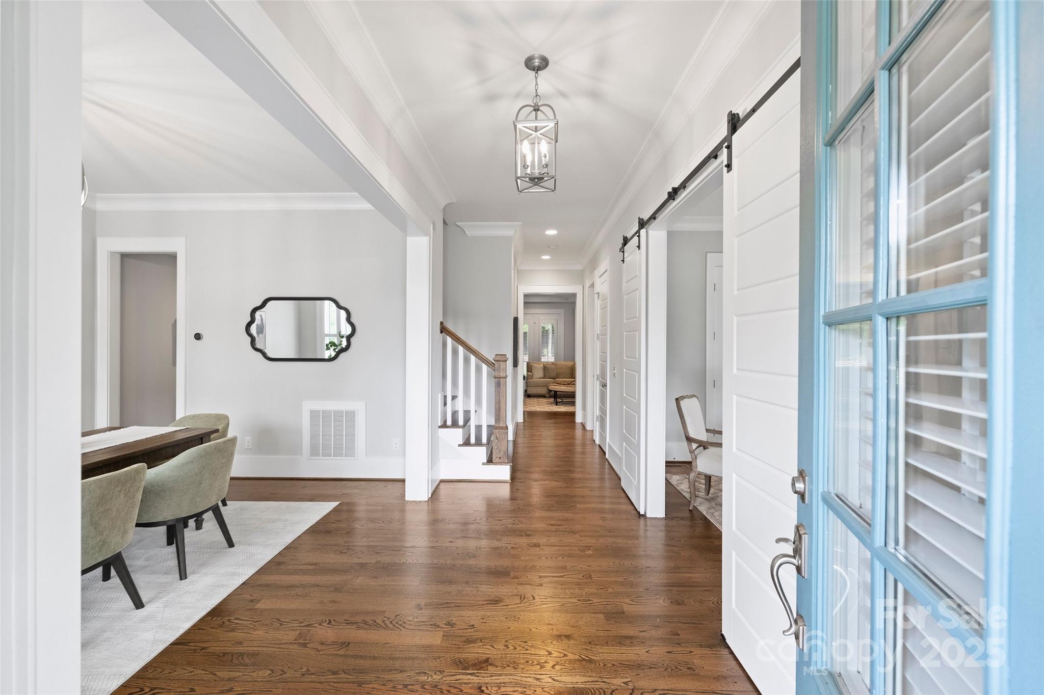 1550 Matthew McClure Circle Davidson, NC 28036 - Photo 4 of 38 a view of a hallway with wooden floor windows and a chandelier