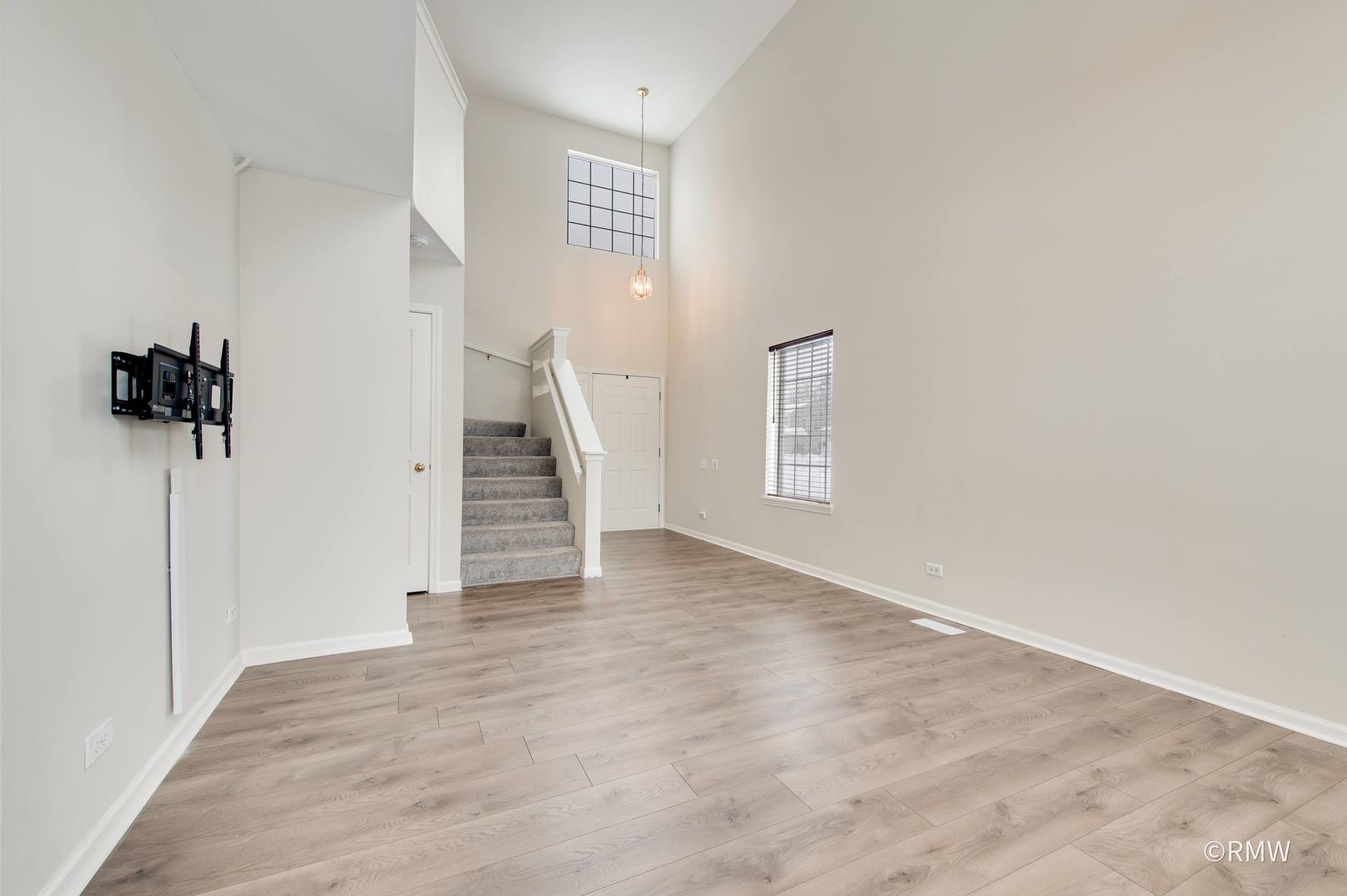1223 Summersweet Lane Bartlett, IL 60103 - Photo 4 of 22 a view of empty room with wooden floor and fan
