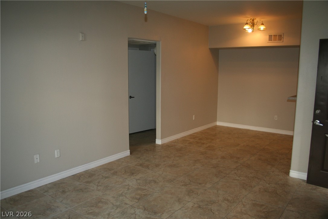 7255 West Sunset Road, Unit 1021 Las Vegas, NV 89113 - Photo 3 of 7 Smooth tile flooring and clean lines define this versatile open living space.