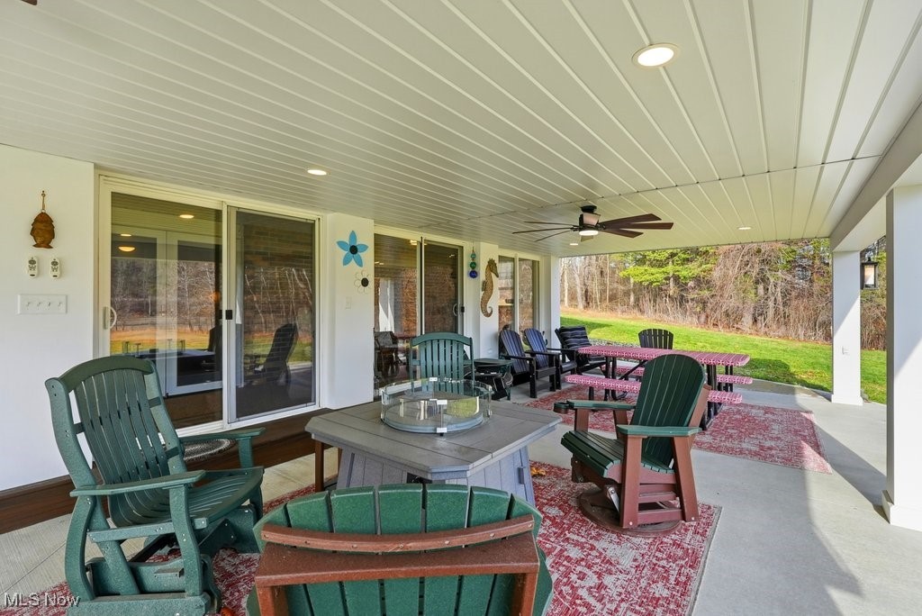 1430 Magnolia Road Southwest Dellroy, OH 44620 - Photo 40 of 50 Covered patio with multiple seating areas, ideal for entertaining, dining, or simply enjoying the outdoors year-round.