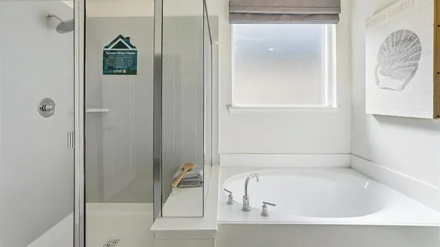 a bathroom with a tub and shower