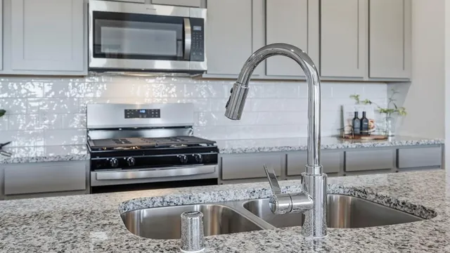 a kitchen with sink a stove and microwave