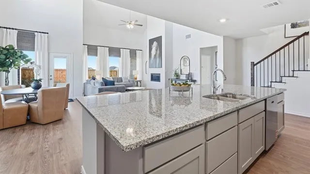 a dining hall with stainless steel appliances granite countertop a kitchen island a stove a table and chairs