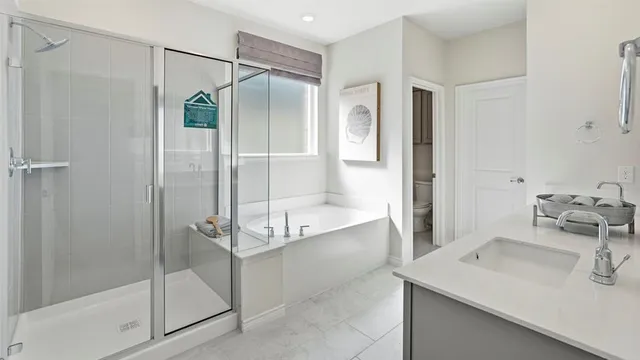 a bathroom with a shower sink and mirror