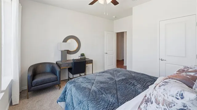 a bedroom with a bed and a chair